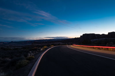 Empty road against sky during sunset