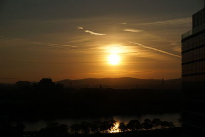 Silhouette buildings against sky during sunset