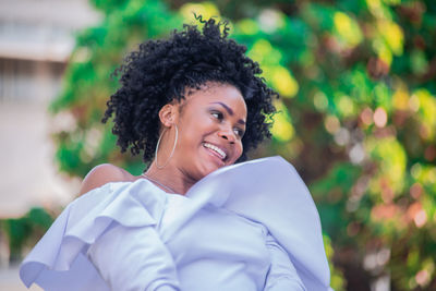 Portrait of smiling young woman standing outdoors