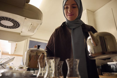 Woman preparing evening tea at home