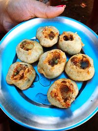 High angle view of hand holding food in plate