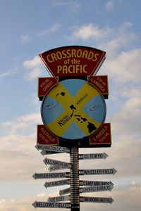 Low angle view of road sign against sky