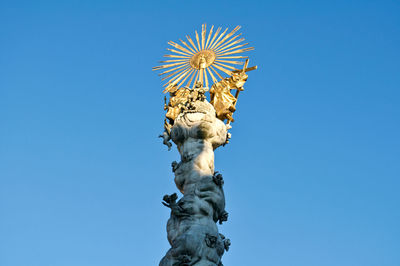 Low angle view of statue against clear blue sky