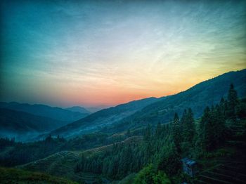 Scenic view of mountains against sky at sunset