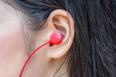 Cropped image of woman listening to music