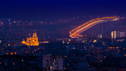 Illuminated cityscape against sky at night