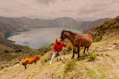 Full length of man standing on field against mountains