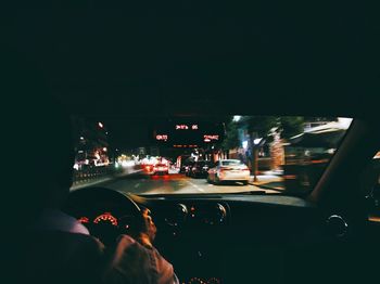 People in illuminated city at night