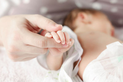 Close-up of baby girl sleeping on bed