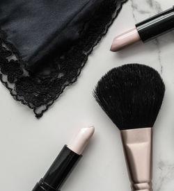 High angle view of make-up brushes on white background