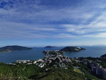 Scenic view of sea by buildings against sky