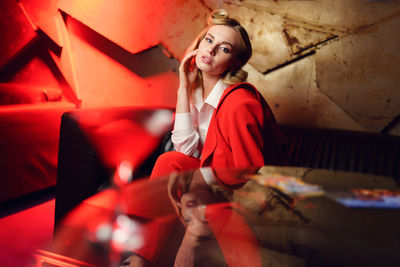 Portrait of young woman sitting on sofa