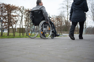 A physically disabled person on a wheelchair at a walk