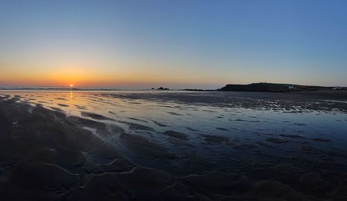 Scenic view of sea against clear sky during sunset