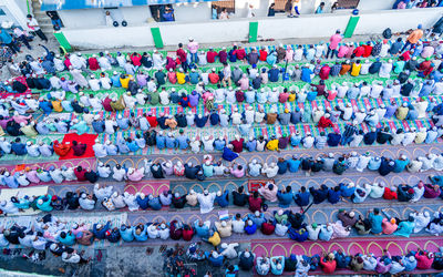 High angle view of crowd praying on road