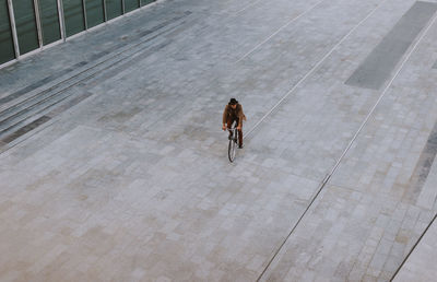 Rear view of woman walking on road in city