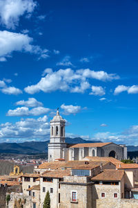 Buildings in town against sky