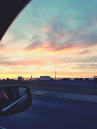 Car on road against sky during sunset