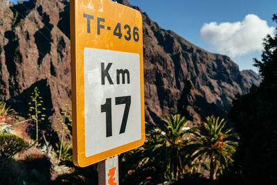 Close-up of road sign against trees