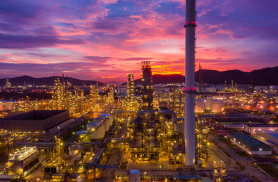 High angle view of illuminated city against sky at sunset