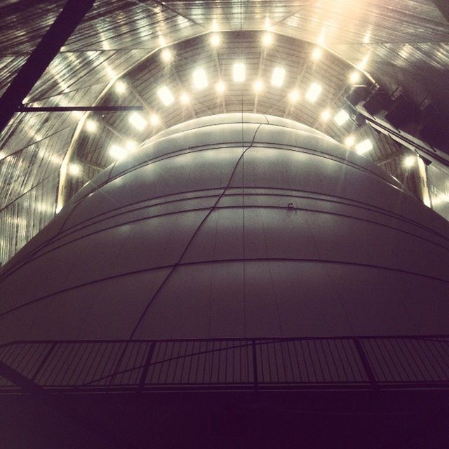 indoors, low angle view, modern, architecture, illuminated, built structure, pattern, escalator, railing, reflection, glass - material, ceiling, no people, steps, steps and staircases, staircase, building, building exterior, night, architectural feature