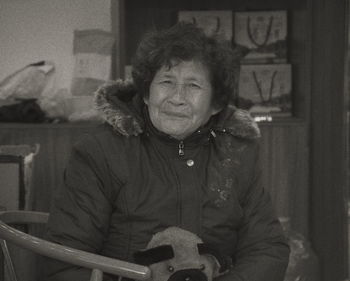 Portrait of a smiling young woman sitting at home