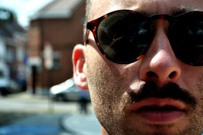 Close-up portrait of young man wearing sunglasses