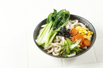 High angle view of food in plate on white background