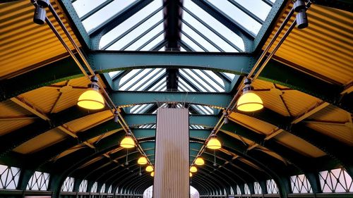 Low angle view of ceiling at railroad station against sky