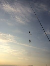 Low angle view of silhouette birds flying against sky during sunset