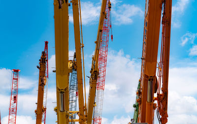 Crawler crane against blue sky and white clouds. real estate industry. red crawler crane .