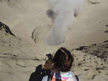 Rear view of woman on snowcapped mountain