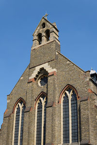 The stone exterior of st mary magdalene church of england church near wandsworth common, london. 