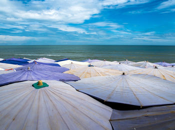 Large umbrellas crowded along the beach