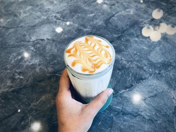 High angle view of hand holding drink