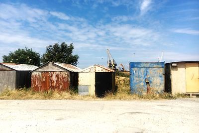 Abandoned house on field against sky