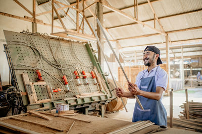 Portrait of man standing in factory