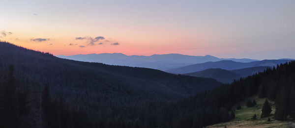 Scenic view of mountains against sky during sunset