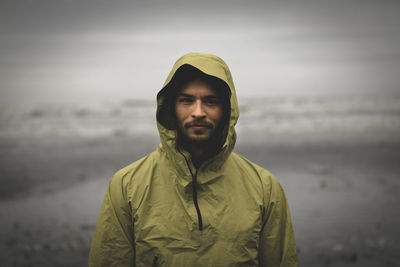 Portrait shot of adventurous looking male during bad weather