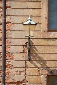 Low angle view of street light mounted on wall