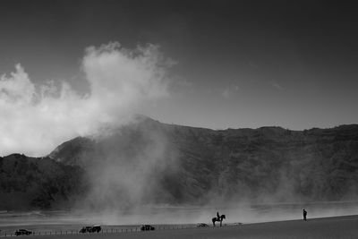 Panoramic view of people on landscape against sky