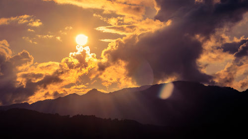 Scenic view of silhouette mountains against sky during sunset