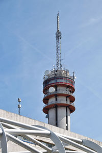 Low angle view of communications tower against sky