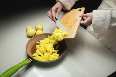 Close-up of raw potatoes for frying. housewife preparing a dish with potatoes in a frying pan in the