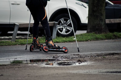 Low section of person skating on street