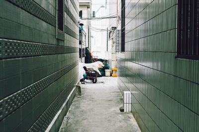 People working in alley amidst buildings