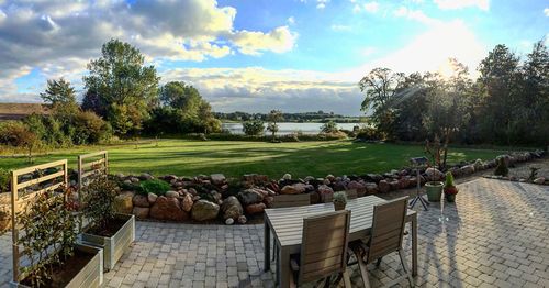 Trees on field against cloudy sky