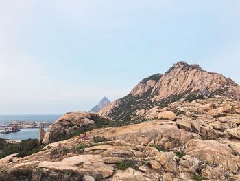 Scenic view of sea and mountain against clear sky