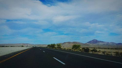 Empty road passing through landscape