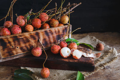 Lychees with wood and burlap on table